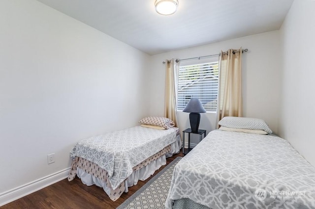 bedroom with dark hardwood / wood-style floors