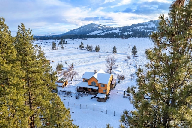 snowy aerial view featuring a mountain view