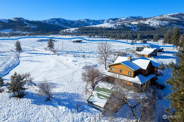 snowy aerial view featuring a mountain view