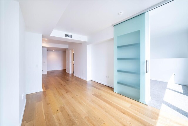 empty room with light hardwood / wood-style flooring