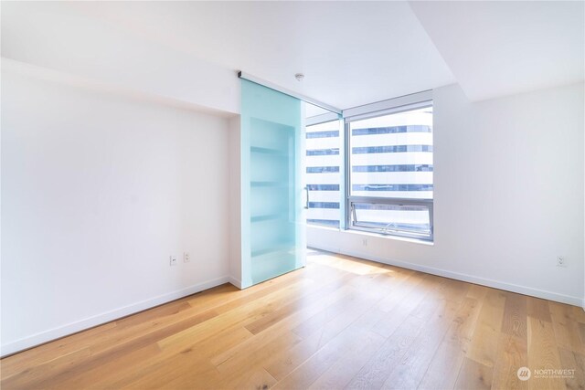 spare room featuring light wood-type flooring