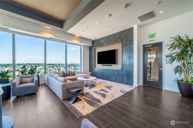 living room featuring dark hardwood / wood-style floors and tile walls