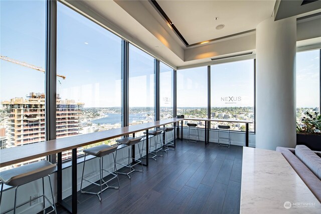 sunroom featuring a water view