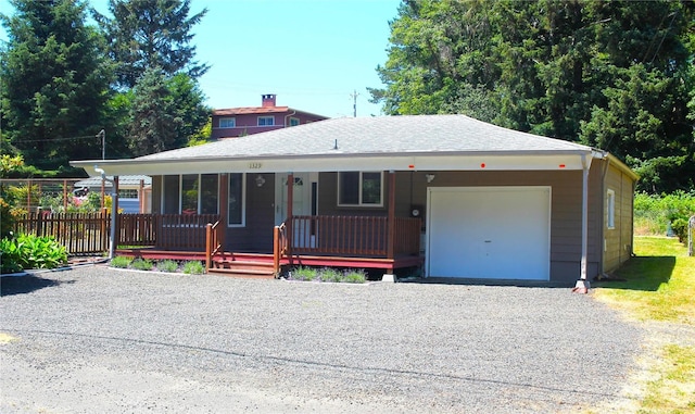 view of front of property with a porch and a garage