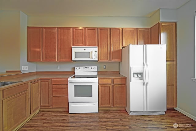 kitchen with white appliances and dark hardwood / wood-style floors