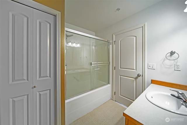 bathroom with vanity and enclosed tub / shower combo