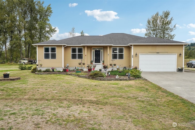 ranch-style home featuring a garage and a front lawn