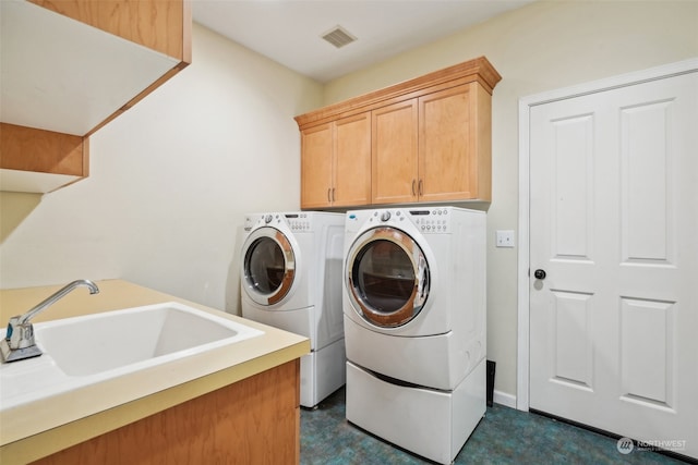 laundry area with cabinets, sink, and washer and dryer