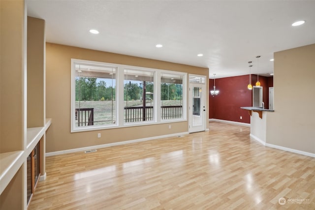 unfurnished living room with light hardwood / wood-style floors