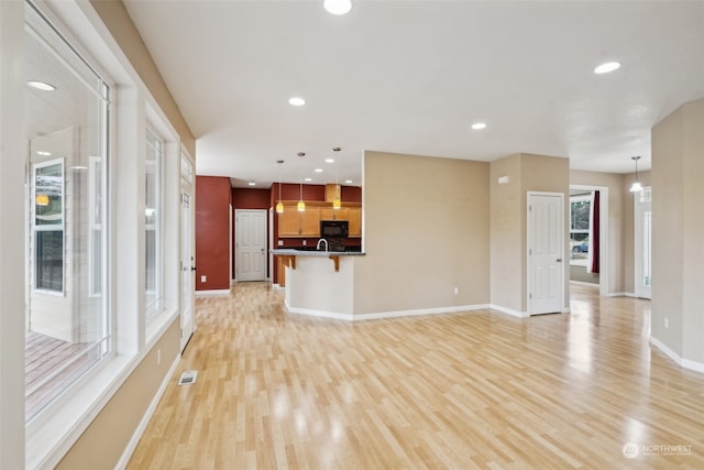 unfurnished living room with light wood-type flooring