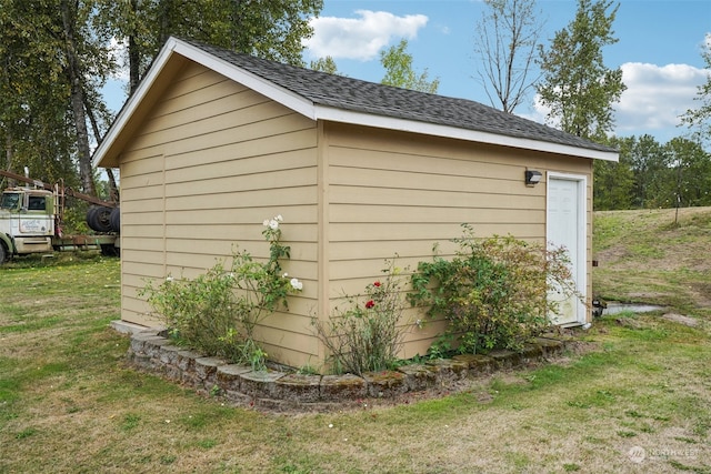 view of outbuilding with a lawn