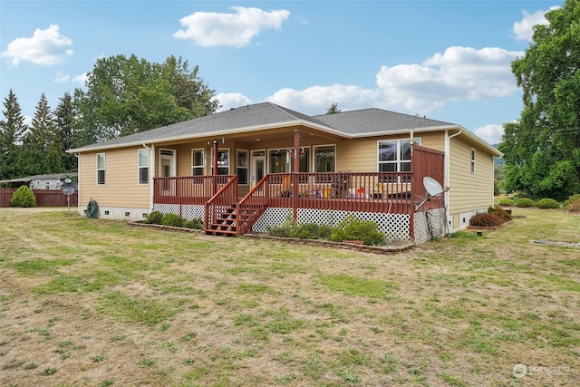 rear view of property with a deck and a yard