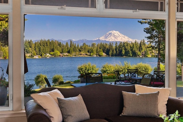 exterior space with a water and mountain view and a view of trees