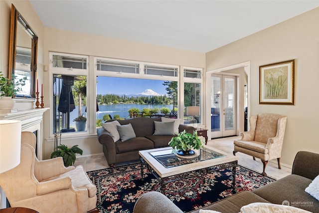 living room featuring a water view, french doors, and a wealth of natural light