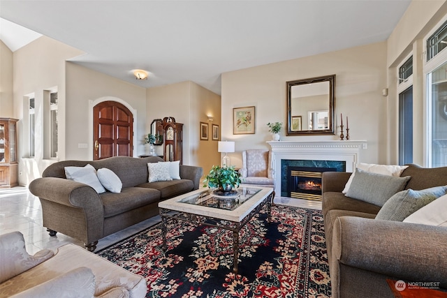 living room with a fireplace, tile patterned flooring, and a healthy amount of sunlight