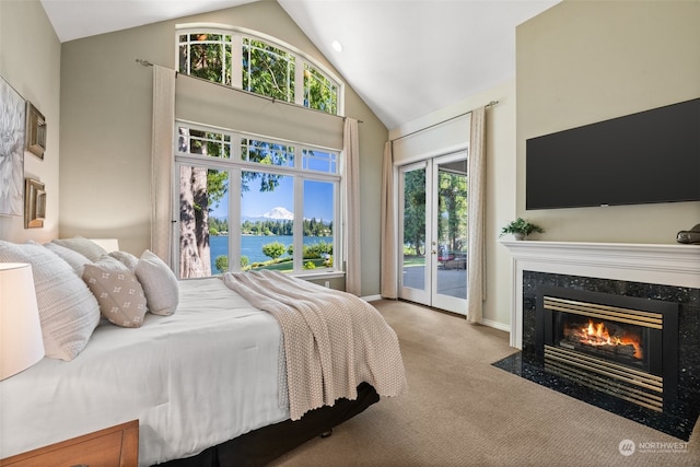 bedroom with a water view, access to exterior, light carpet, a high end fireplace, and high vaulted ceiling