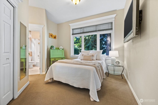 bedroom featuring carpet flooring and ensuite bath