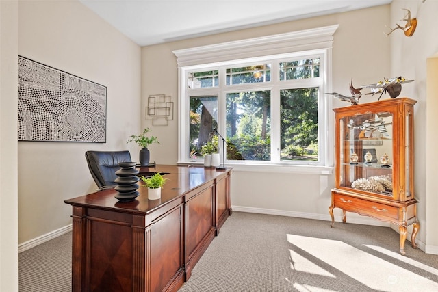 home office featuring light carpet and baseboards