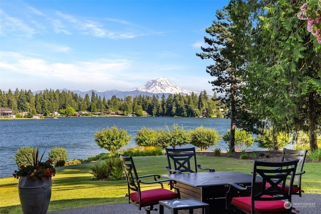 exterior space with a water and mountain view