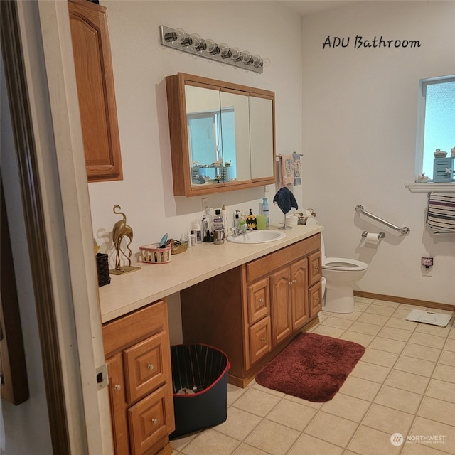 bathroom with tile patterned flooring, vanity, and toilet