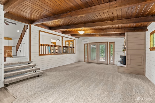 unfurnished living room with ceiling fan, french doors, wooden walls, carpet, and wood ceiling