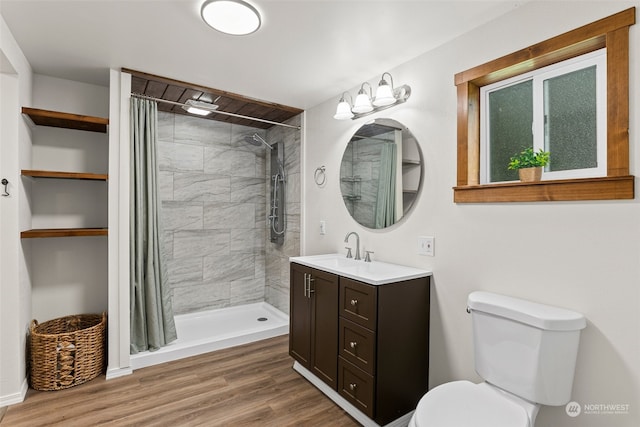 bathroom featuring a shower with curtain, vanity, wood-type flooring, and toilet