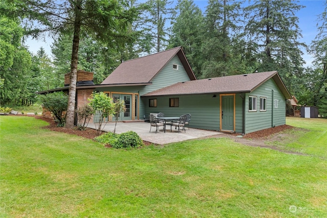 rear view of house featuring a yard and a patio