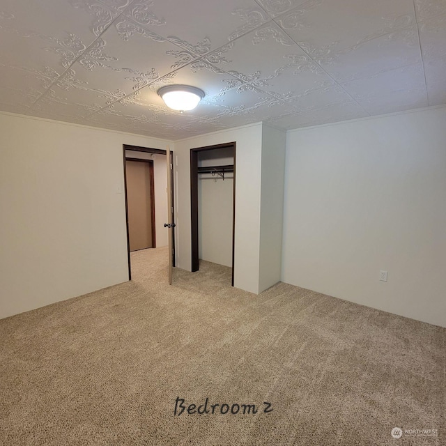 unfurnished bedroom with carpet floors and a closet