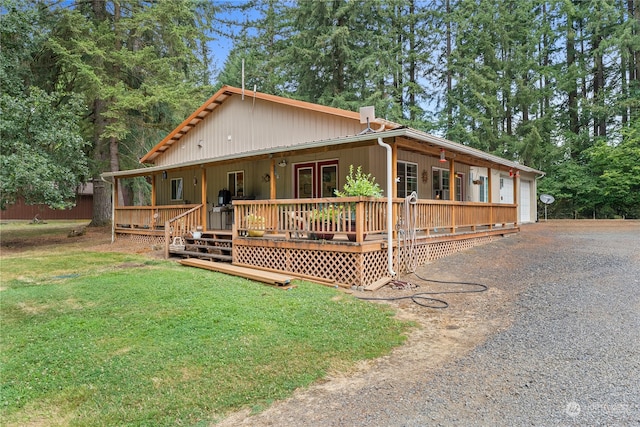 country-style home with a front lawn, covered porch, and french doors