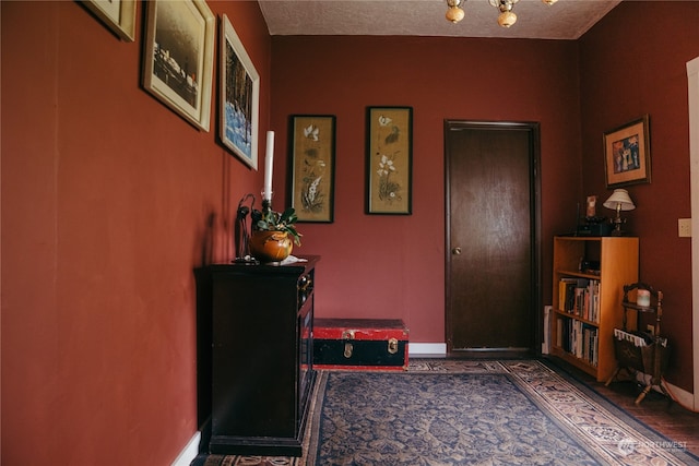 interior space featuring dark wood-type flooring and a textured ceiling