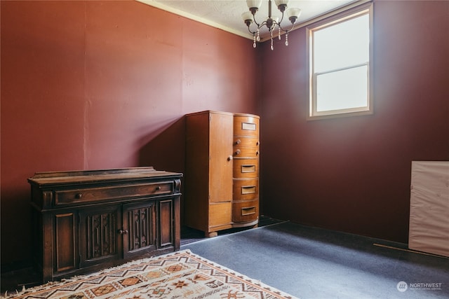 unfurnished bedroom with carpet floors and a notable chandelier