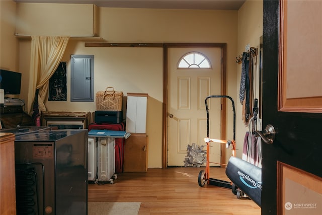 entryway with light hardwood / wood-style floors and electric panel