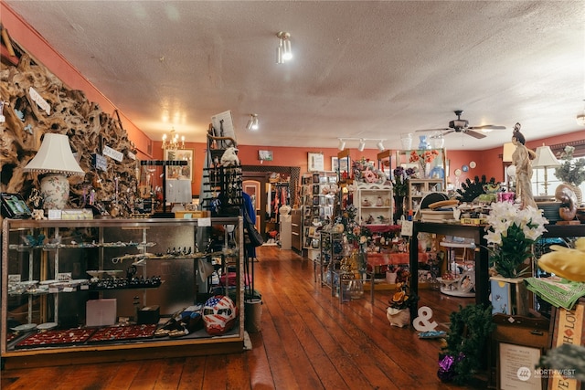 miscellaneous room with wood-type flooring, a textured ceiling, ceiling fan, and track lighting