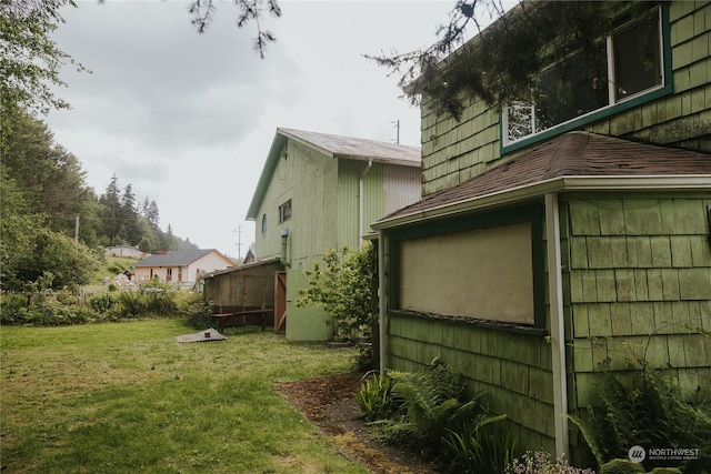 view of side of home featuring a yard