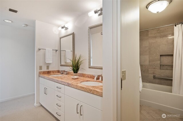 bathroom with shower / tub combo and dual bowl vanity