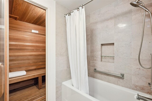 bathroom with hardwood / wood-style floors, shower / bath combo, and wood ceiling