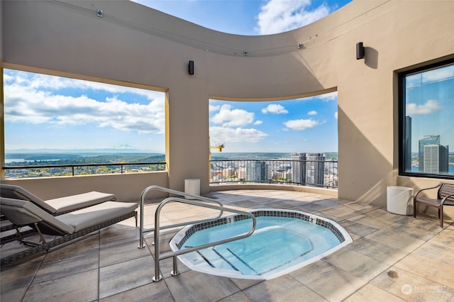 view of swimming pool featuring an in ground hot tub