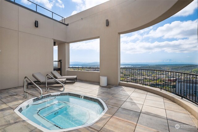 view of swimming pool featuring a mountain view and an in ground hot tub