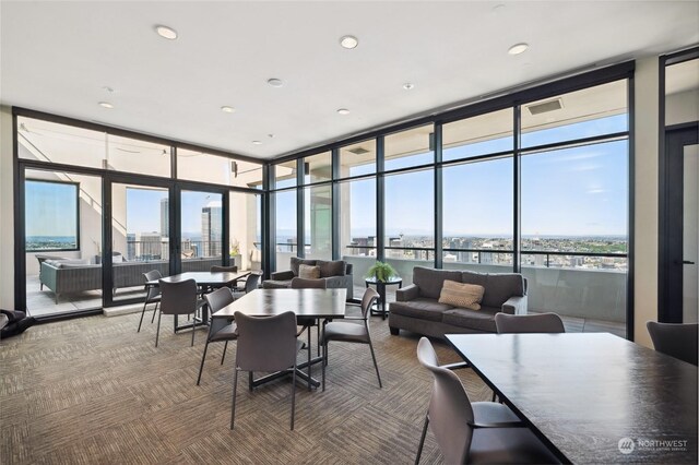 interior space featuring a wall of windows, carpet flooring, and a wealth of natural light