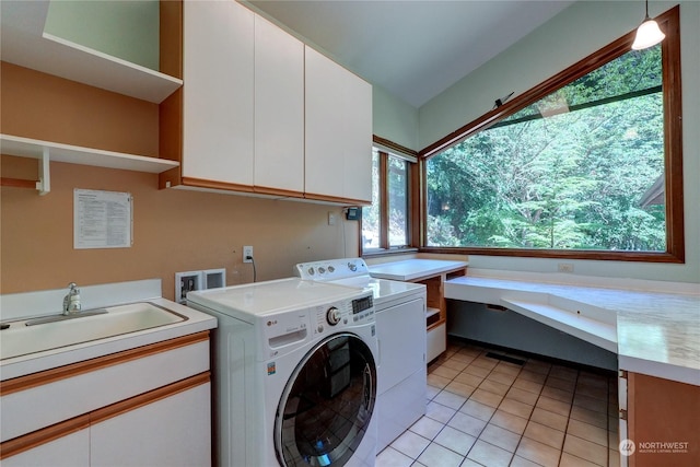 laundry area featuring plenty of natural light, cabinets, sink, and light tile patterned flooring