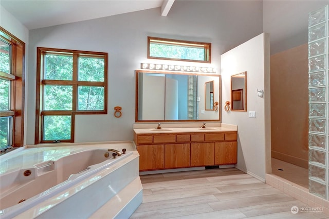 bathroom featuring plus walk in shower, hardwood / wood-style floors, vanity, and lofted ceiling with beams