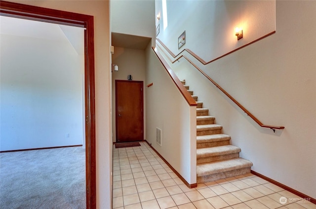 stairway with tile patterned flooring