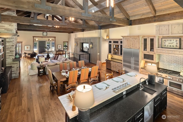 kitchen featuring light brown cabinets, high vaulted ceiling, dark wood-type flooring, sink, and high end appliances