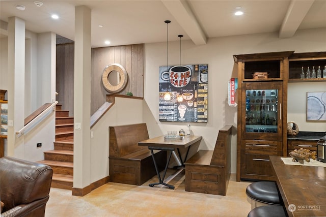 bar with beamed ceiling and decorative light fixtures