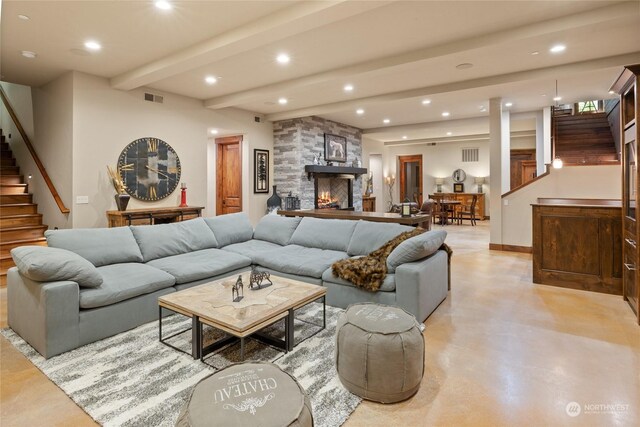 living room with beamed ceiling and a fireplace