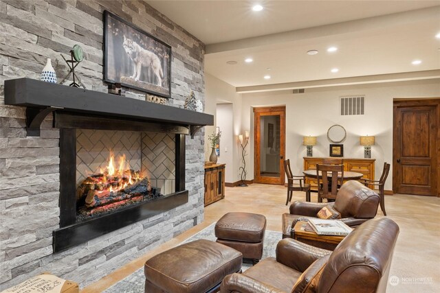 living room featuring a stone fireplace