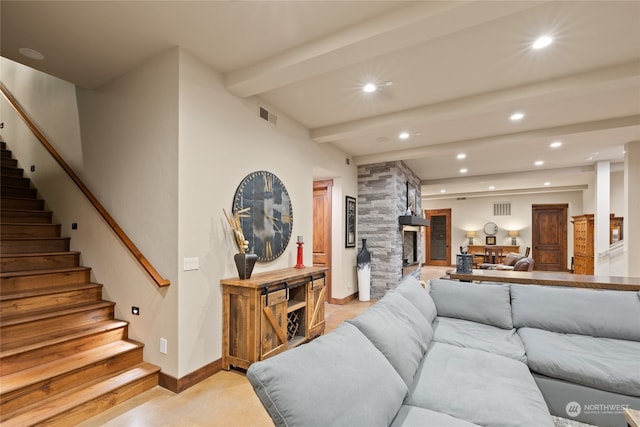 living room with beamed ceiling and a fireplace