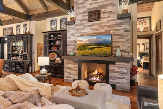 living room featuring dark hardwood / wood-style flooring, beamed ceiling, high vaulted ceiling, and wooden ceiling