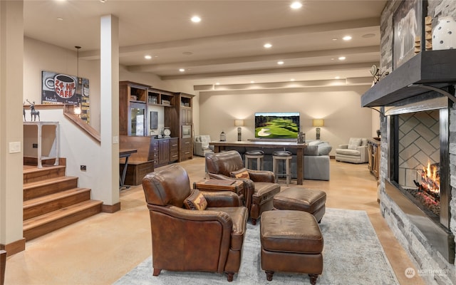 cinema with beam ceiling and a fireplace