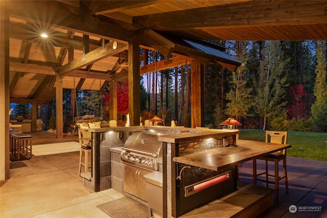 view of patio / terrace featuring a gazebo, area for grilling, and an outdoor kitchen